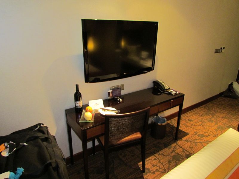 The work desk sits underneath a massive TV, but isn't the best ergonomically.